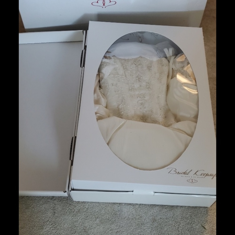 Lovely size 8 ivory wedding dress.  Professionally cleaned, sealed, and stored.